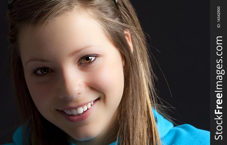 An attractive young blond woman against a black background. An attractive young blond woman against a black background