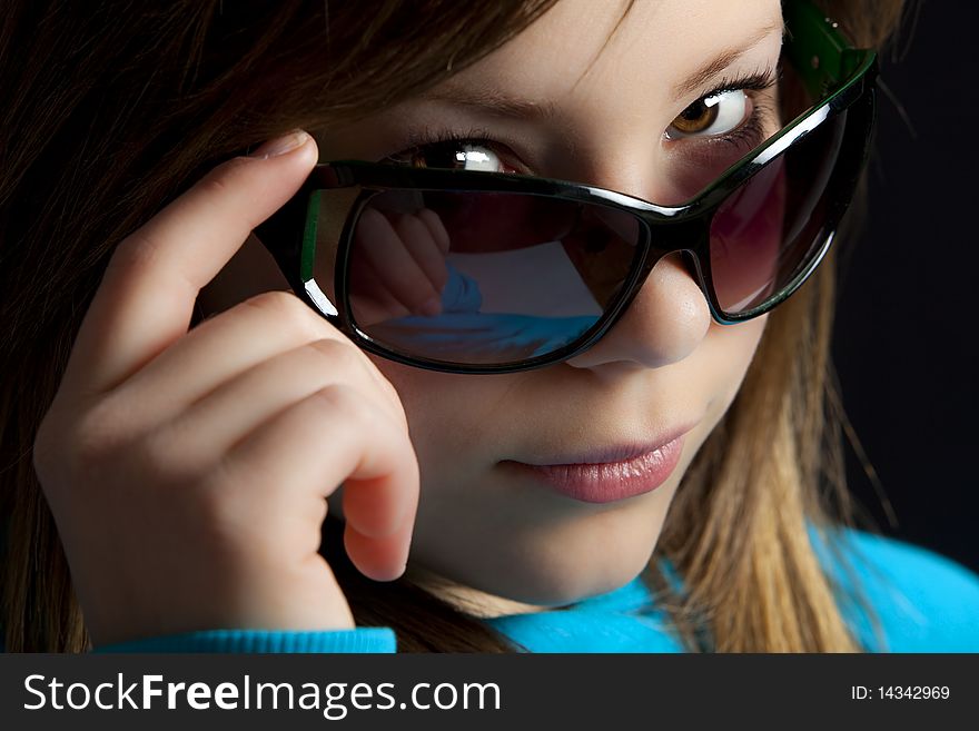 An attractive young blond woman against a black background. An attractive young blond woman against a black background