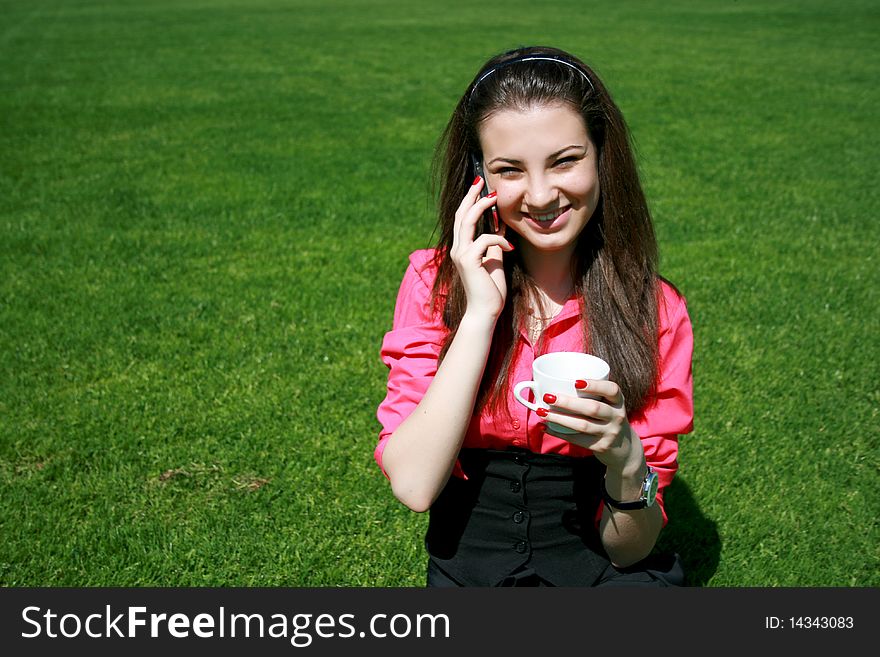 Young businesswoman drinking tea and talking