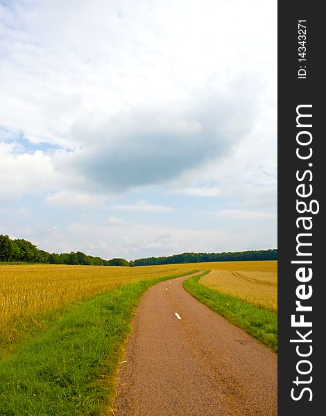 Highway in landscape with cloudy sky