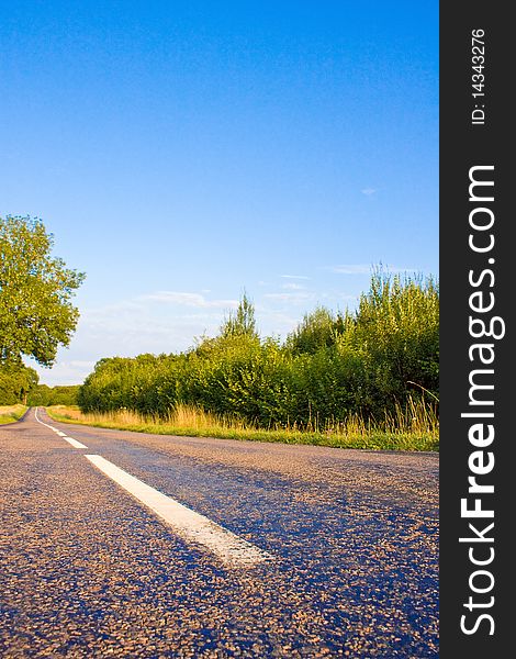 Highway in landscape with cloudy sky