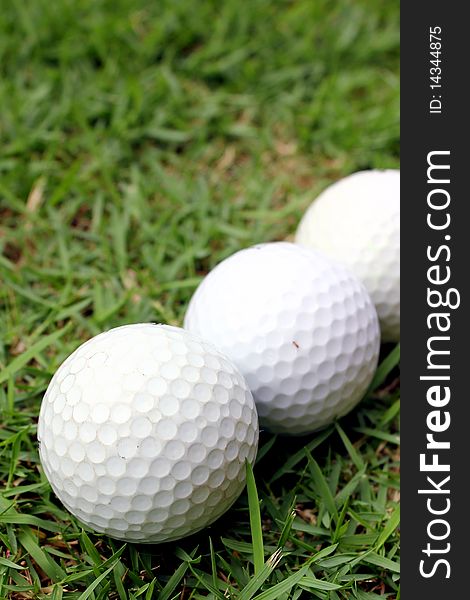 Golf balls lying on the green grass