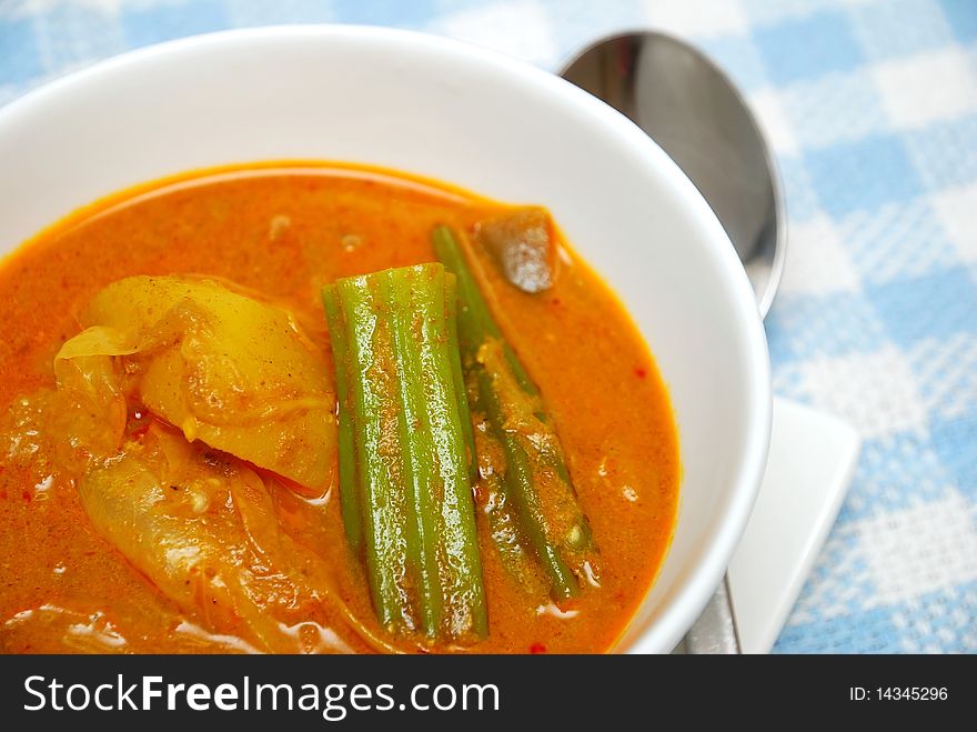 Asian spicy vegetarian curry. Ingredients include potatoes, lady fingers, and tomatoes. Suitable for Asian food culture, healthy lifestyle, and diet and nutrition.