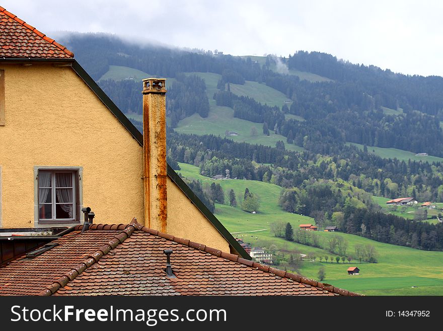 Old tile roof against a mountain landscape