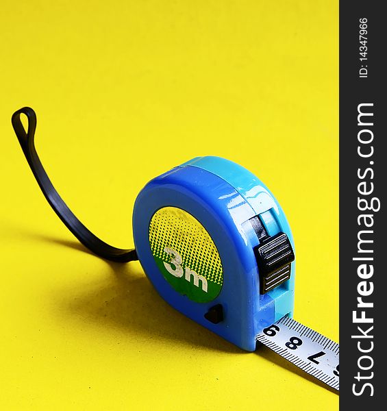 A measuring tape isolated on yellow background