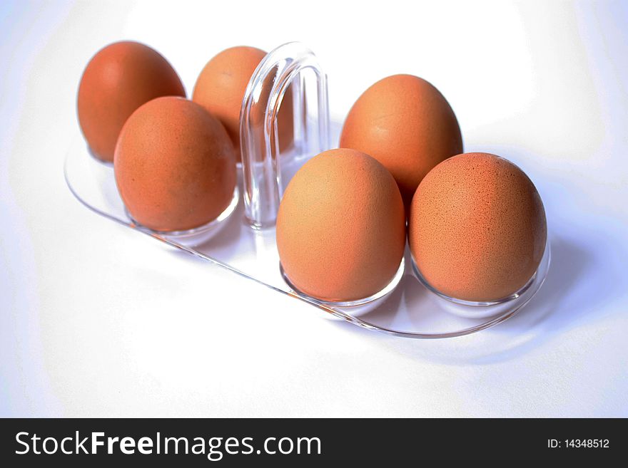 Brown eggs in tray on white background