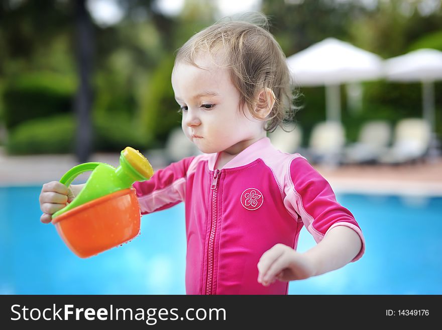 Cute toddler girl playing in swimming pool. Cute toddler girl playing in swimming pool