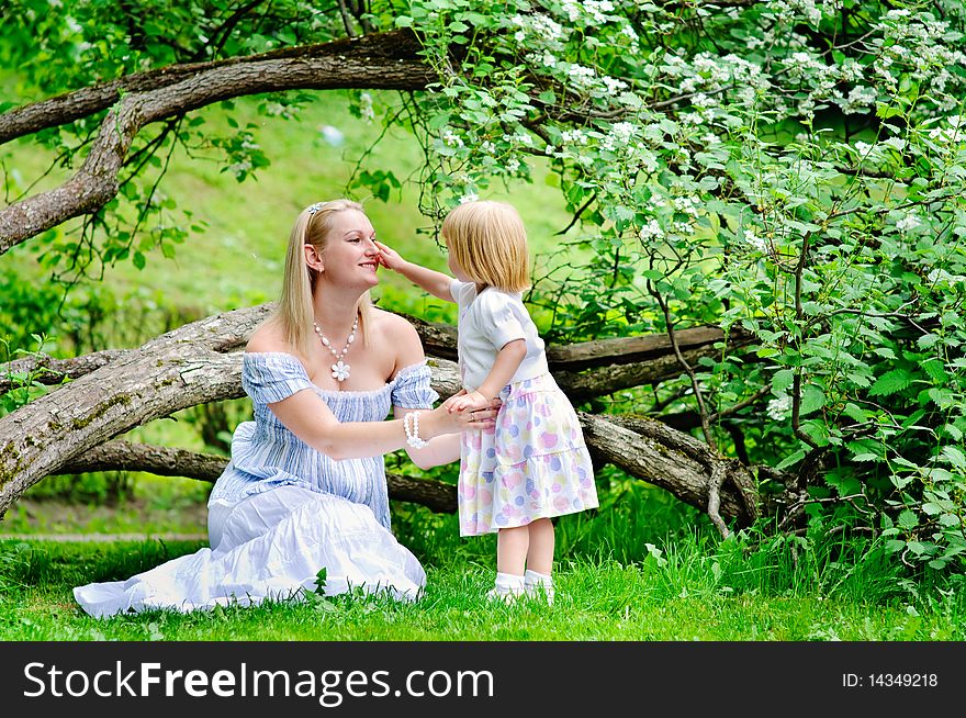 Mother and daughter in blooming garden