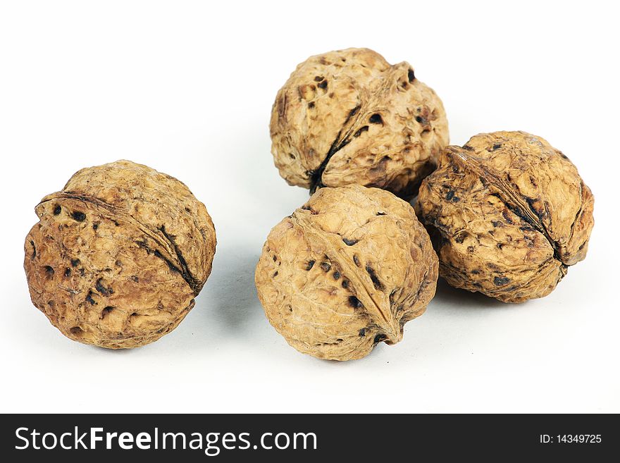 Four whole Walnuts on white background