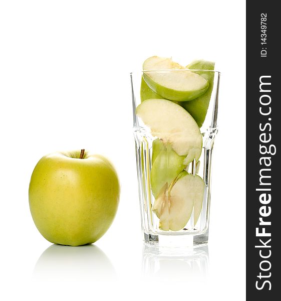 Apple and slices in glass isolated on white background