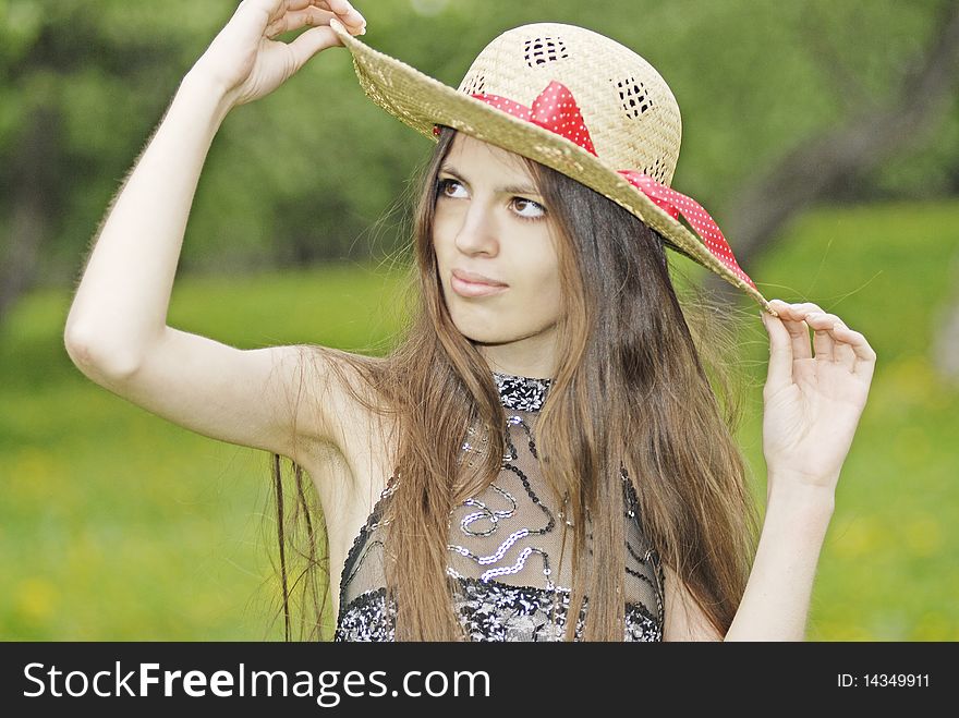 Girl with long hair in straw hat