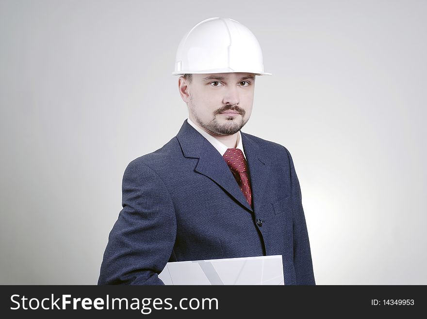 A man in a building helmet with a folder