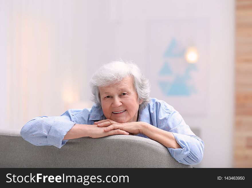 Portrait of beautiful grandmother in living room. Portrait of beautiful grandmother in living room