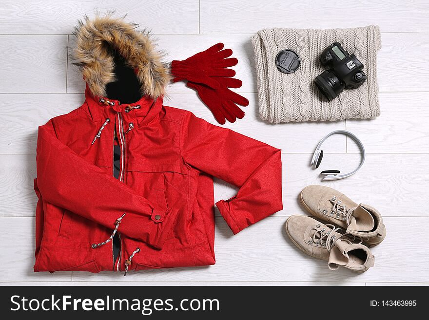 Flat lay composition with warm clothes for winter vacation on background