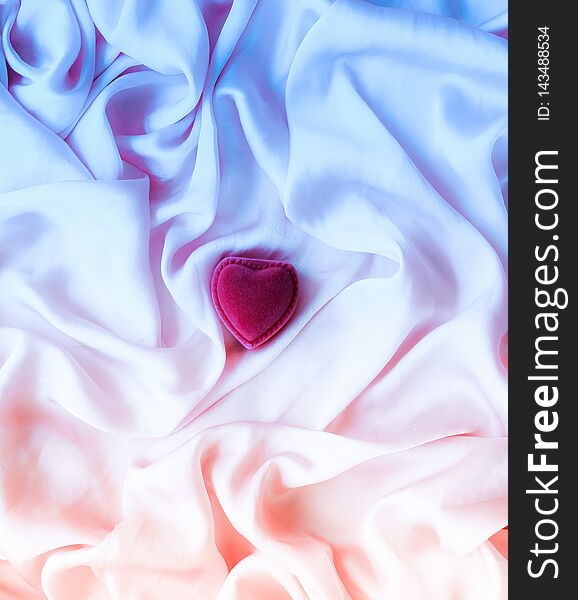 Valentine\'s day, true love, engagement and proposal concept - Heart-shaped gift box on neon silk. Will you be my Valentine