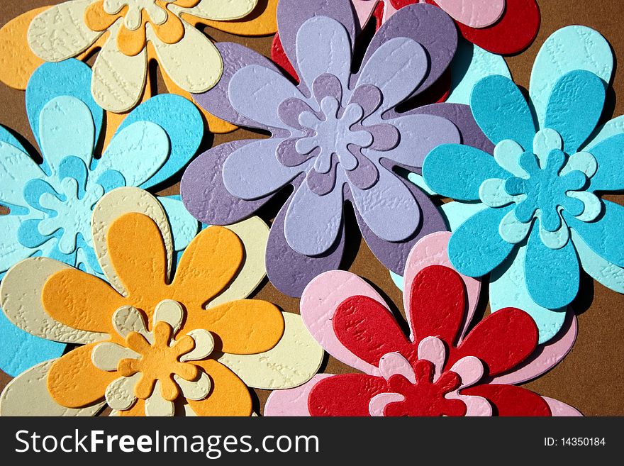 Colorful paper flowers on brown background. Colorful paper flowers on brown background