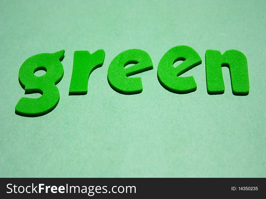 Green foam letter word on green background