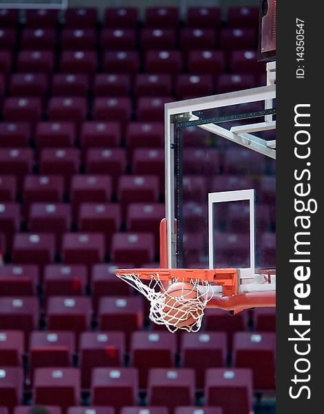 A basketball going through the hoop into the net. A basketball going through the hoop into the net