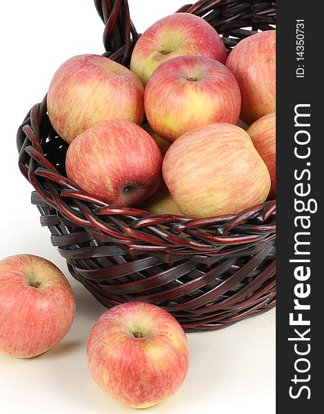A basket with red ripe apples on white