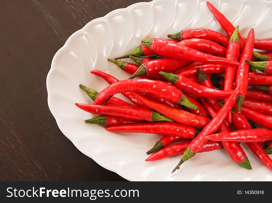 Composition of red chili pepper in white plate