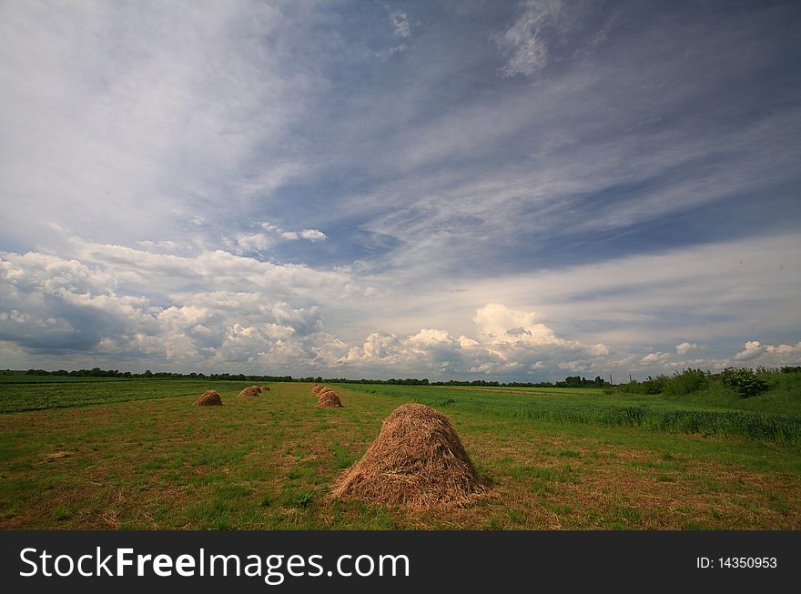 Rural scenery in spring and haystacks