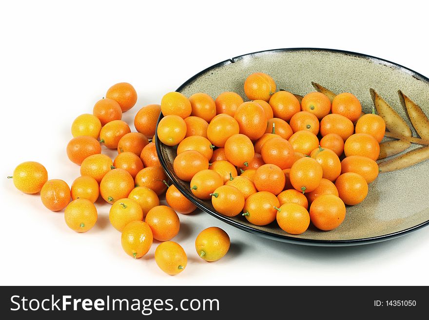 A group of  yellow tomatoes photographed on a white background