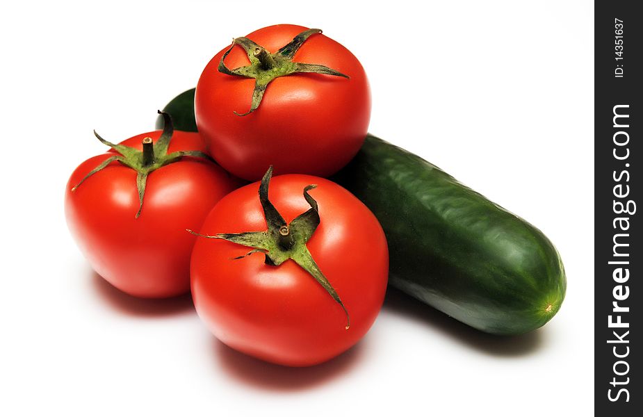 Tomatoes and cucumber isolated on white