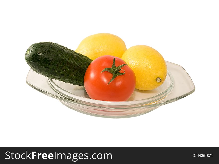 Fruits and vegetables on plate isolated on white background