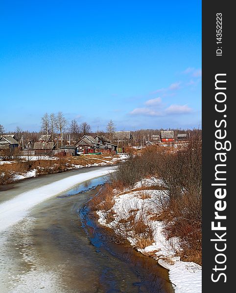 Village on spring coast river