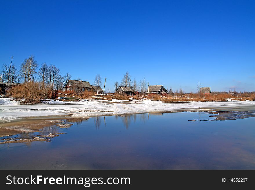 Village on spring coast river