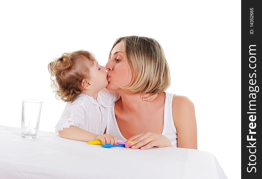 Young mother and her young daughter hugged and kissed each other on a white background