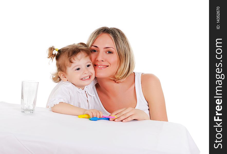 Young mother and her young daughter hugged and kissed each other on a white background