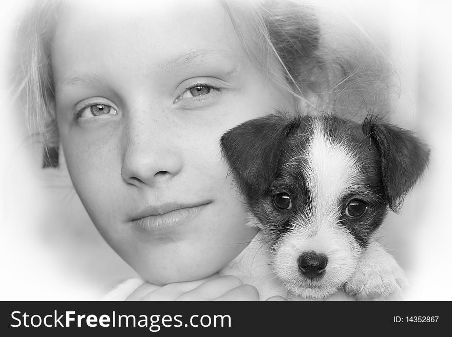 Beautiful young girl smiling and holding her puppy. Beautiful young girl smiling and holding her puppy