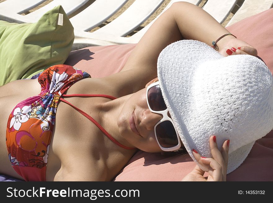 Portrait of a pretty girl sunbathing on a beach.