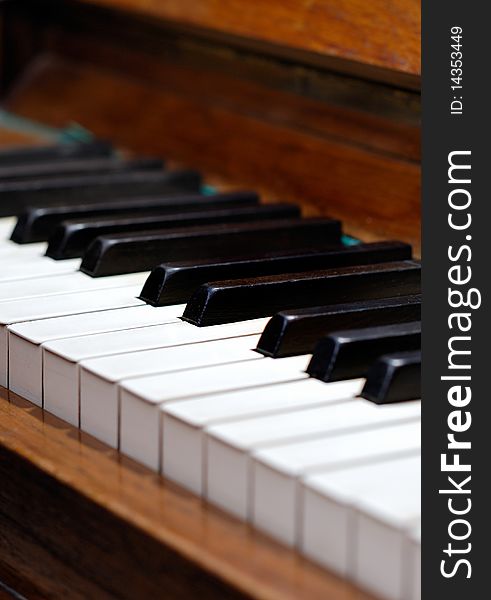 Old wood piano with white and black keys