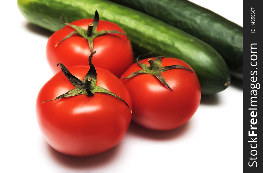 Tomatoes and cucumbers isolated on white