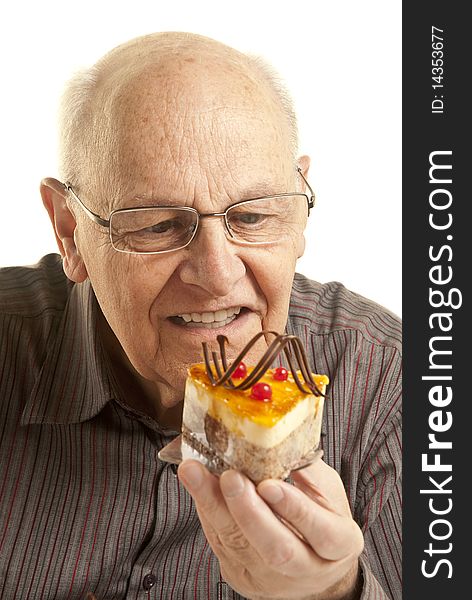 Senior man eating a cake, isolated on white