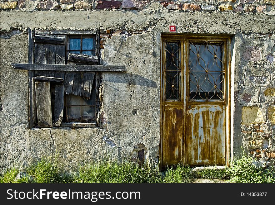 An abandoned building with a window and door. An abandoned building with a window and door