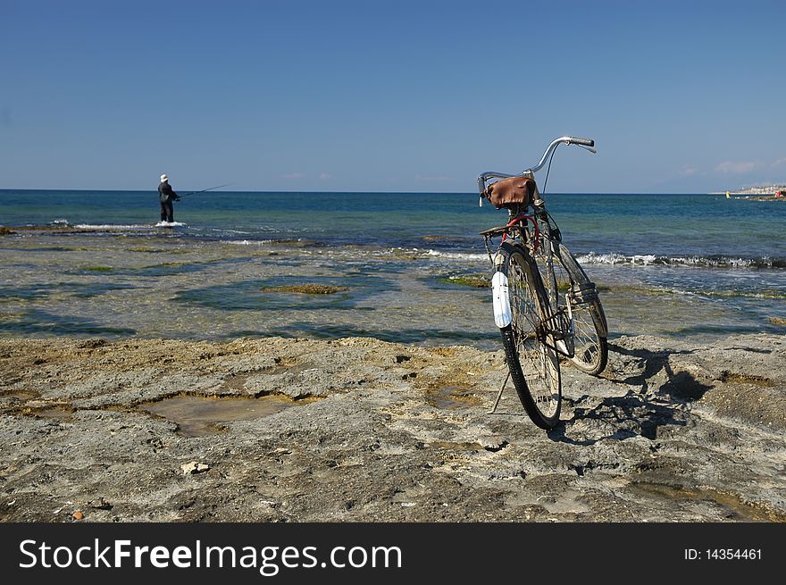 Fisherman's bicycle parked at the sea shore