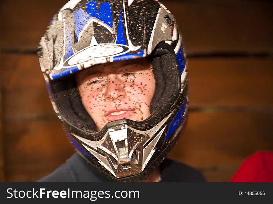 Young boy is fascinated by quart driving and enjoyes it, his face is dirty from mud. Young boy is fascinated by quart driving and enjoyes it, his face is dirty from mud