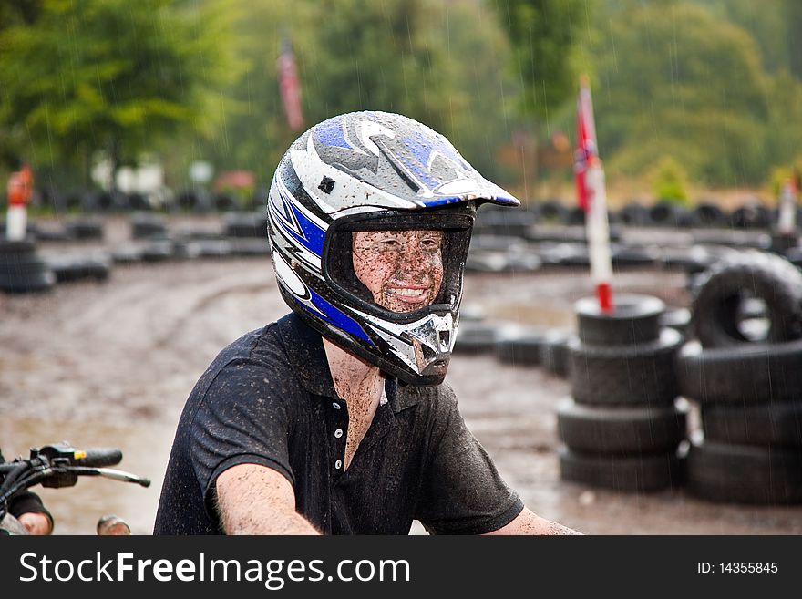 Young boy is faszinated by quad driving and enjoyes is, his face is dirty from mud. Young boy is faszinated by quad driving and enjoyes is, his face is dirty from mud