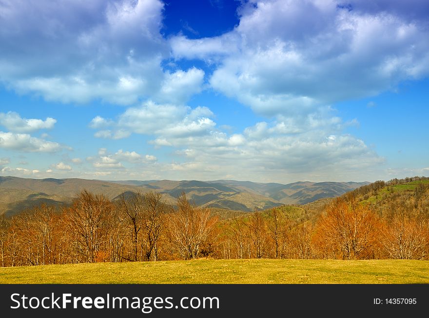 Early spring landscape with blue clody sky