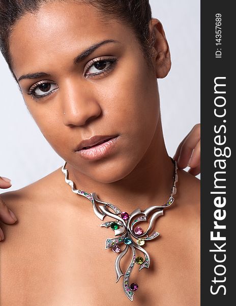 A portrait of a pretty model wearing a colorful necklace. A portrait of a pretty model wearing a colorful necklace