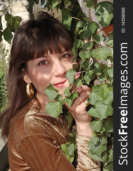 Portrait of beautiful woman in a green park. Portrait of beautiful woman in a green park