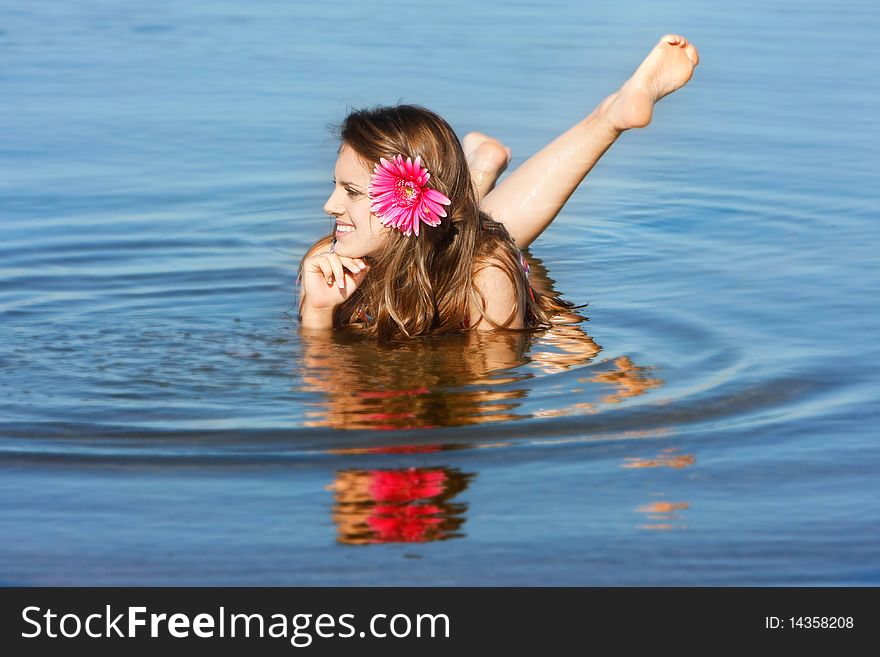 Young beautiful woman relaxing in water. Young beautiful woman relaxing in water