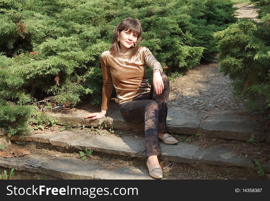 Portrait of beautiful woman in a green park. Portrait of beautiful woman in a green park