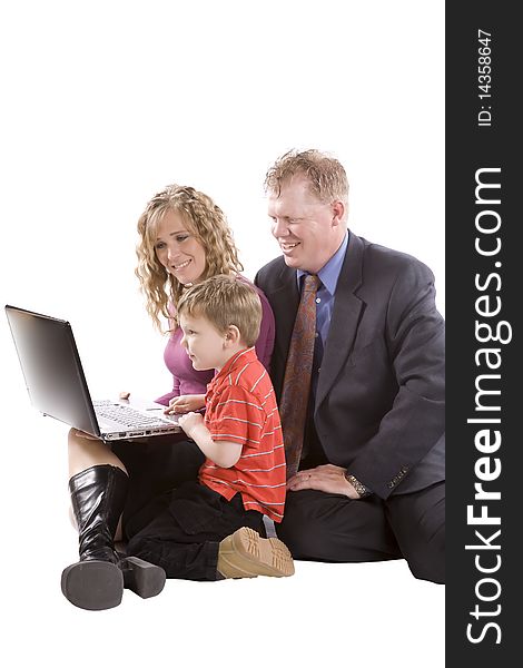 A young boy showing parents things on a computer. A young boy showing parents things on a computer.