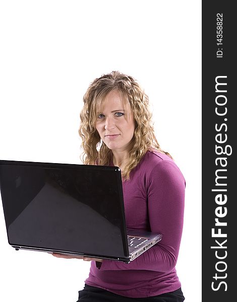 A woman with a smirk on her face holding a laptop. A woman with a smirk on her face holding a laptop.