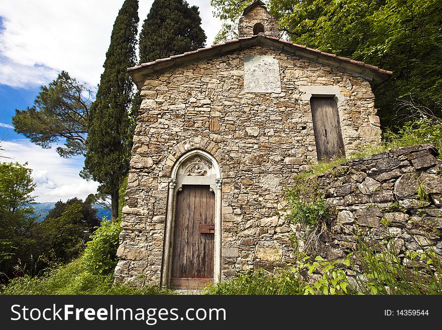 An old stone church desecrated surrounded by nature