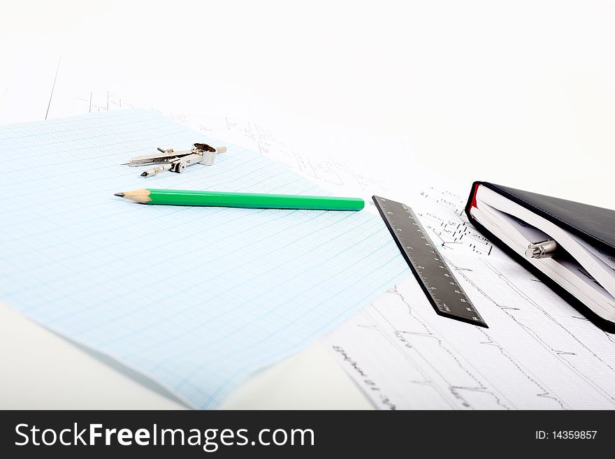 A Compass On A Graph Paper With Notepad